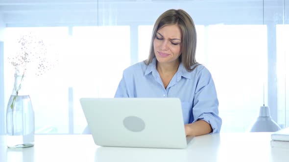 Reaction on  Business Loss on Laptop by Woman at Work