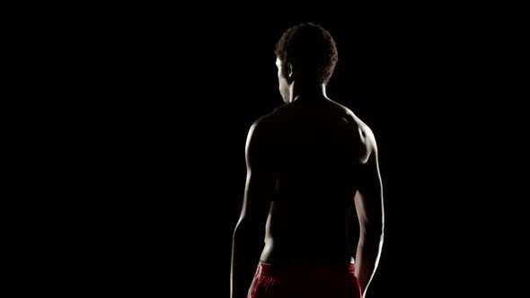 Man Stretching Isolated on Black