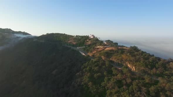 Aerial shot of house by the road in forest on canyon in Malibu Canyon, Monte Nido, California, USA