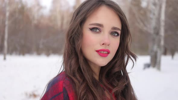 Woman with Red Lips in Winter Forest