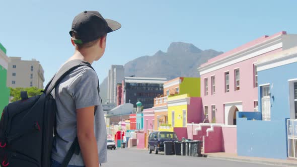 Boy Tourist in Cape Town BoKaap Malay Area Perspective of Cobble Stone Street Colored Terrace Houses