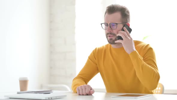 Angry Man Talking on Phone