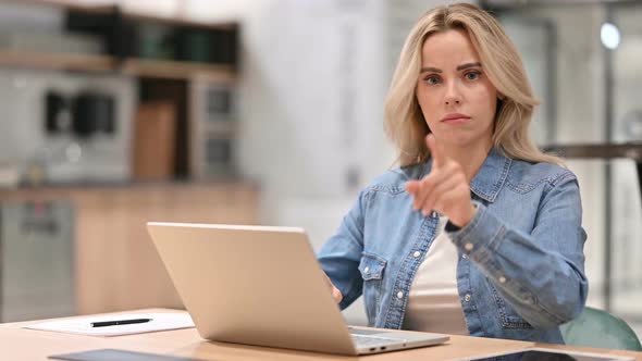 Young Woman with Laptop Showing No Gesture Disapprove