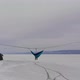 Man Sitting in a Hammock Mounted at High Altitude Over a Frozen Lake - VideoHive Item for Sale
