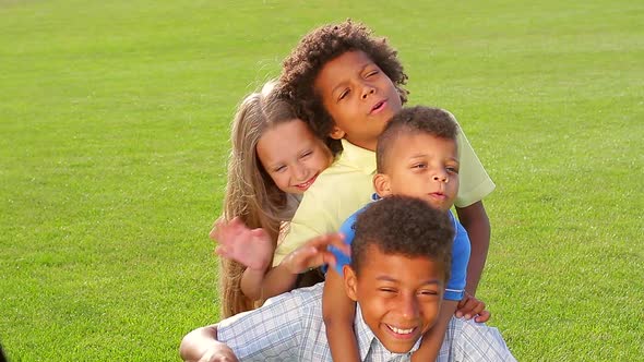 Four Children Are Playing on the Grass