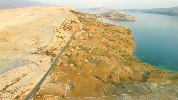 Flying above desert island of Pag at sunset, Croatia