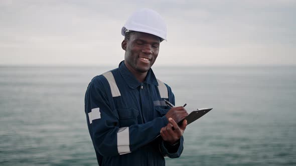 Friendly Black Seaman Making Notes