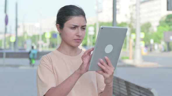 Upset Indian Woman Reacting to Loss on Tablet