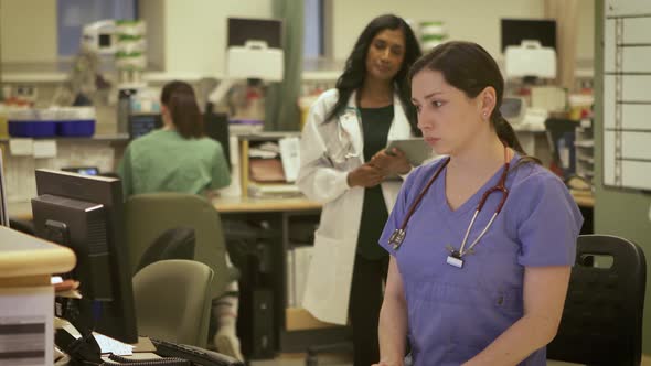 Nurses and Doctors working together in a modern busy hospital.