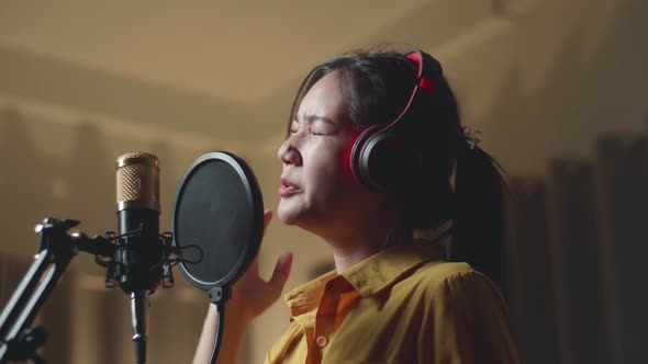 Young Asia Woman Singing In Recording Studio