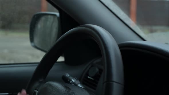 girl wipes a car steering wheel with an antibacterial wipe during a pandemic