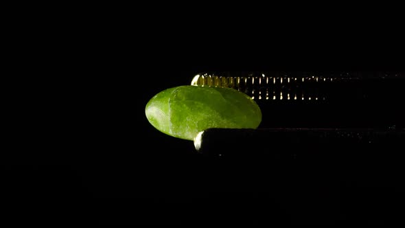 Natural Hydrogrossular Green Garnet in Tweezer on Turn Table