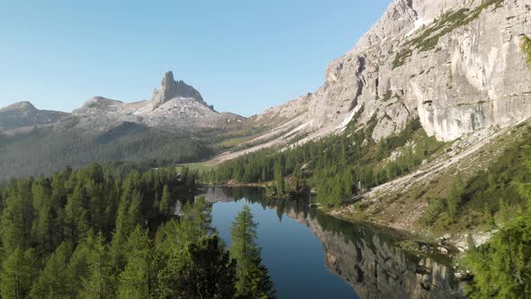 Aerial Flying over Mountain Lake Federa in Dolomites Alps Italy