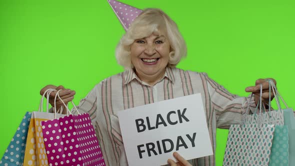 Inscription Advertising Black Friday Appears Next To Joyful Grandmother with Shopping Bags