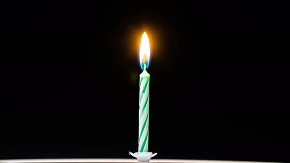 Timelapse of a green candle burning alt