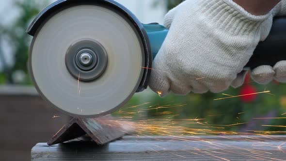 Worker in Protective Gloves Use Angle Grinder