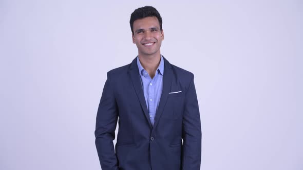 Happy Young Handsome Indian Businessman in Suit Smiling