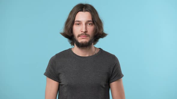 Portrait of Handsome Confident Man with Beard Standing Isolated Over Blue Background Showing Stop or