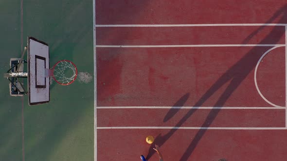 Aerial View. Man Playing Basketball on the Court