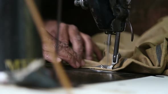 Man working on a sewing machine.