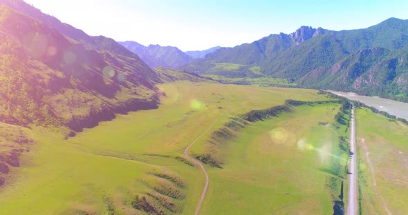 Aerial Rural Mountain Road and Meadow at Sunny Summer Morning