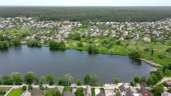 Aerial View of Village, Lake and Forest. 