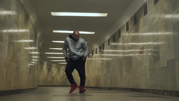 Black Man Dancing Hip-hop in an Underground Crossing