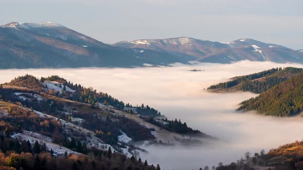 Ukraine, Carpathians. Time Lapse of Morning Fog in the Autumn Winter Mountains. Landscape with Snowy
