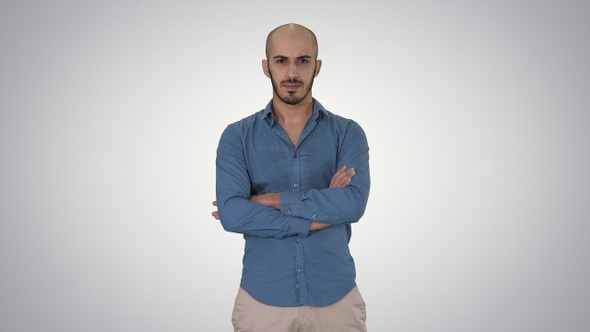 Serious confident arabian man in casual folds hands looking