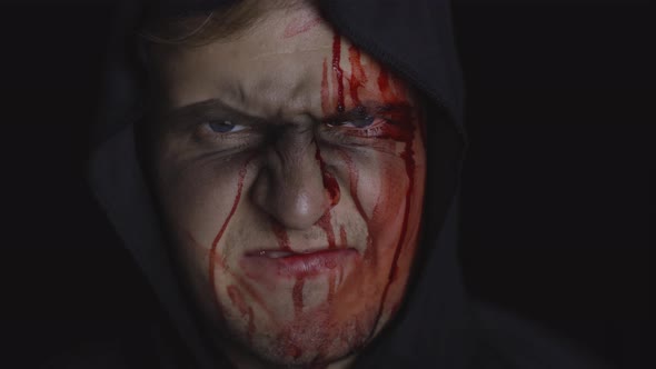 Man Executioner Halloween Makeup and Costume. Guy with Blood on His Face