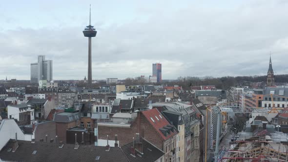 AERIAL: Low Shot Over Germany City Cologne with View of TV Tower on Cloudy Day 