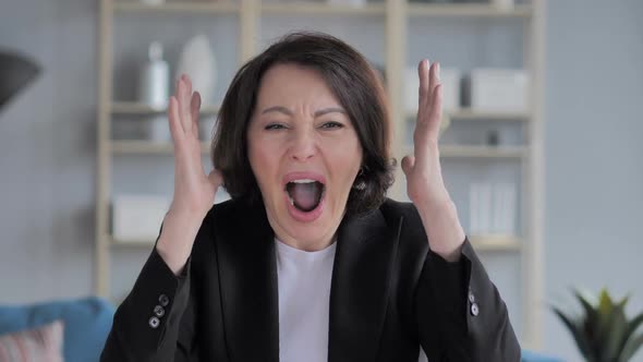 Portrait of Screaming Old Businesswoman Going Crazy