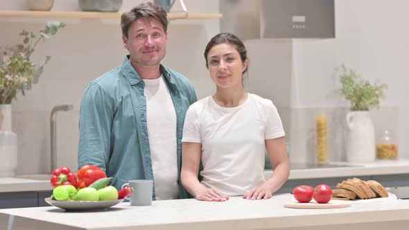 Mixed Race Couple Showing Yes Sign in Kitchen Head Shake