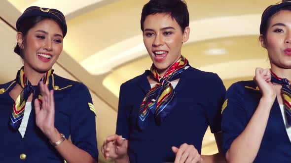 Cabin Crew Dancing with Joy in Airplane