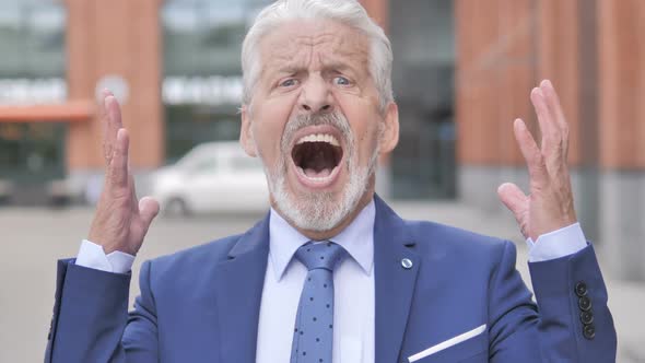 Outdoor Portrait of Screaming Old Businessman Shouting
