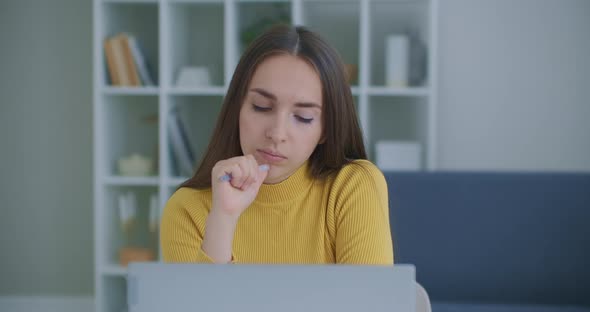 Thoughtful Concerned Indian Woman Working on Laptop Computer Looking Away Thinking Solving Problem