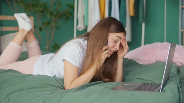 A Young Woman Feels Headache Eye Strain While Working on Laptop in Bed at Home