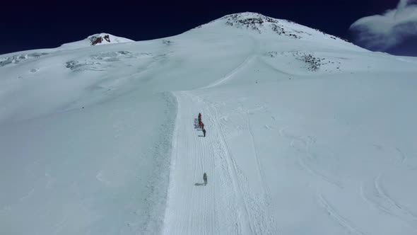 Group of Tourists are Climbing to Mountain in Highlands Aerial View with Sportive People Walking Up