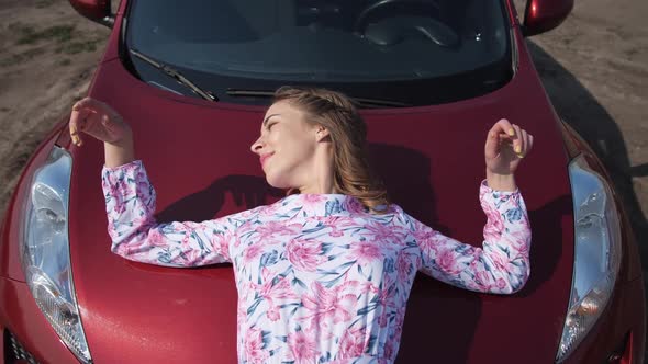 The Girl is Very Gentle on the Hood of the Car