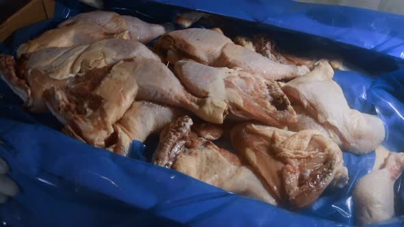 Closeup View of a Box Full of Frozen Chicken Legs