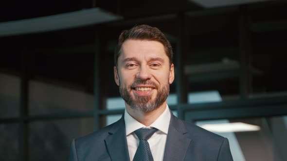 Mature businessman smiling and looking at camera. Mature man in a suit in the office