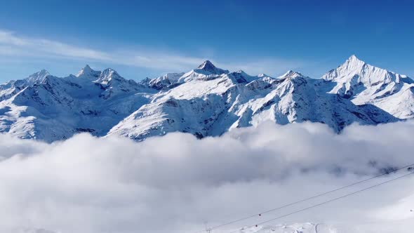 incredibly beautiful snow-covered mountains rise above the sea of ​​fog in switzerland