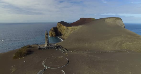 Aerial establishing shot of the abandoned Lighthouse of Ponta dos Capelinhos in the Azores