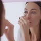Female Curling Eyelashes Near Mirror - VideoHive Item for Sale