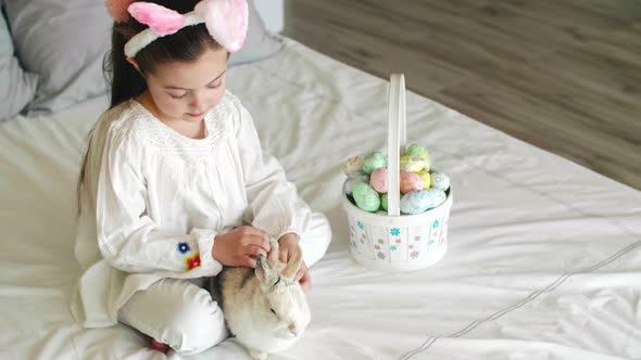 Child and rabbit spending easter morning in bed