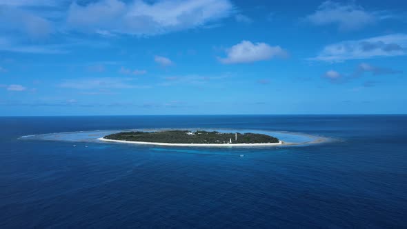 Moving high view of Lady Elliot Island looking across the water of the pacific ocean. Drone view