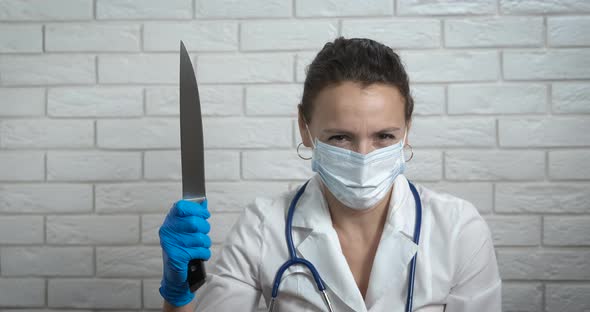 Smiling doctor with knife. 