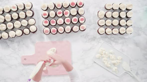 Flat lay. Step by step. Little girl practicing piping buttercream frosting into a cutting board