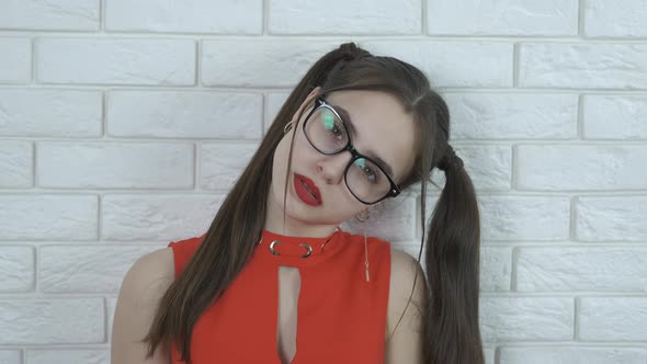 Beautiful girl puts on glasses. 