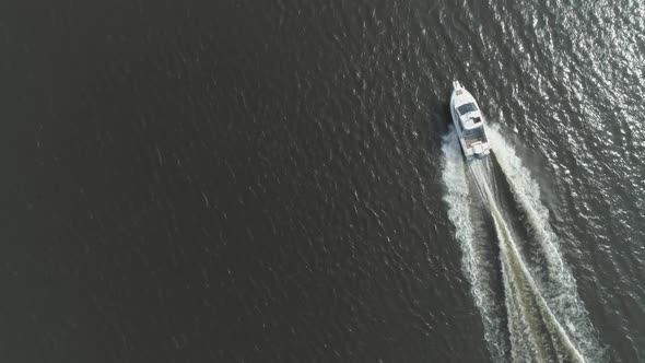 Luxury Speed Motor Boat in the Sea at Sunny Day. Aerial Vertical Top-Down View